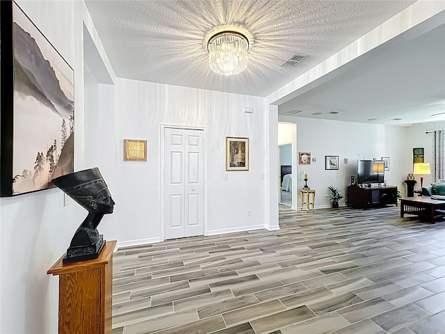 865 Bay Bridge Cir, Apopka, FL 32703 - entryway with a chandelier, wood finished floors, baseboards, and a textured ceiling