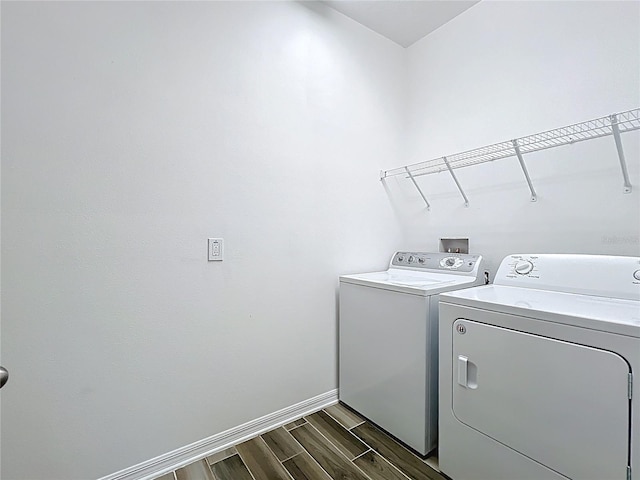 865 Bay Bridge Cir, Apopka, FL 32703 - laundry room featuring independent washer and dryer, dark wood-style flooring, and baseboards