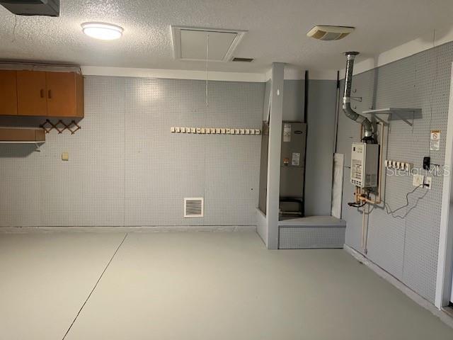 6419 Borg St, Leesburg, FL 34748 - basement featuring water heater and visible vents