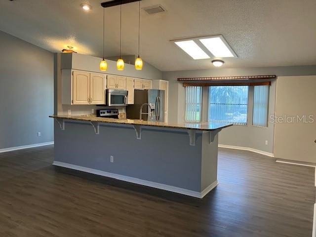 6419 Borg St, Leesburg, FL 34748 - kitchen with a breakfast bar, appliances with stainless steel finishes, and dark wood-type flooring