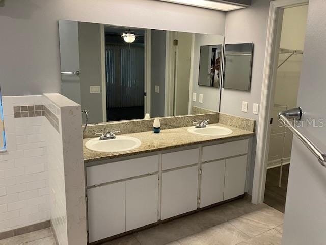 6419 Borg St, Leesburg, FL 34748 - bathroom with a walk in closet, double vanity, tile patterned floors, and a sink