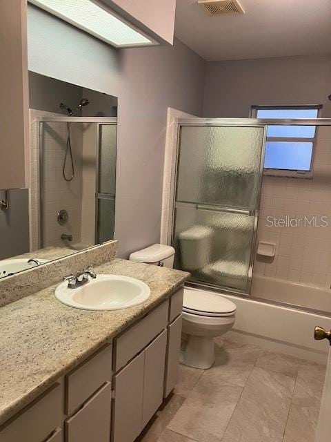 6419 Borg St, Leesburg, FL 34748 - bathroom featuring visible vents, combined bath / shower with glass door, vanity, and toilet