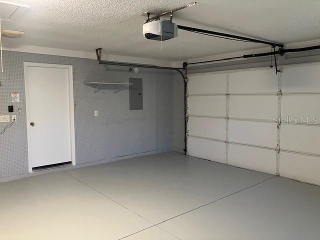 6419 Borg St, Leesburg, FL 34748 - garage with electric panel and a garage door opener