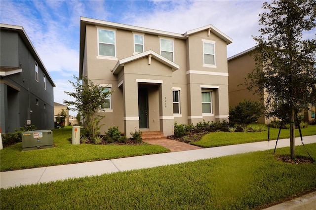 traditional home with a front yard and stucco siding