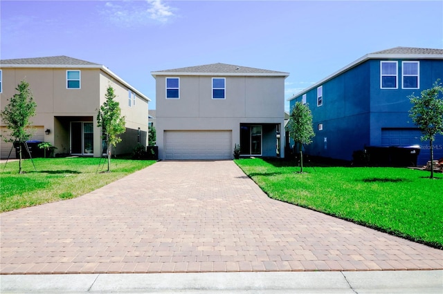 view of front of house featuring an attached garage, a front lawn, stucco siding, and decorative driveway