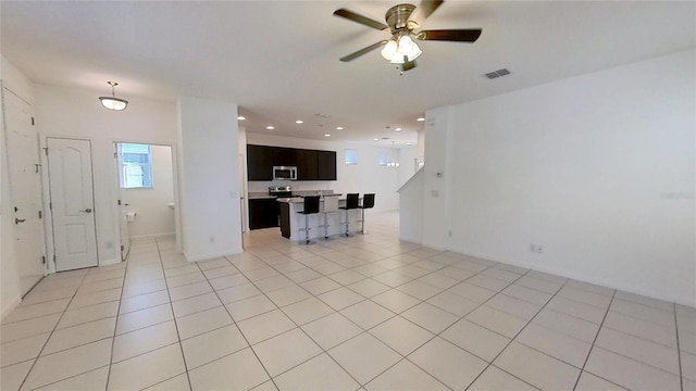 unfurnished living room featuring ceiling fan, light tile patterned flooring, visible vents, and recessed lighting