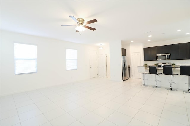 living area featuring a ceiling fan and recessed lighting