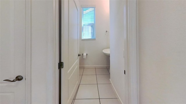 bathroom with baseboards and tile patterned floors