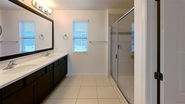 full bath with a healthy amount of sunlight, a stall shower, and a sink
