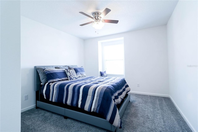 carpeted bedroom with baseboards and ceiling fan