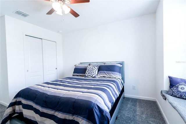 carpeted bedroom with a closet, visible vents, baseboards, and ceiling fan
