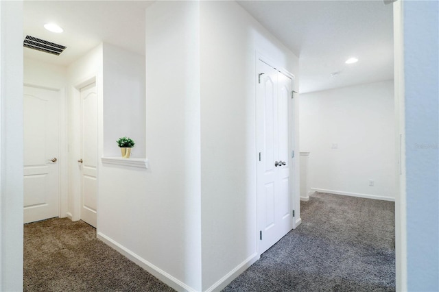 hallway featuring baseboards, carpet flooring, visible vents, and recessed lighting