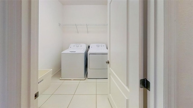 laundry room with washer and dryer, tile patterned flooring, and laundry area