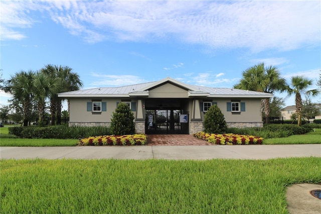 single story home with stone siding, driveway, fence, and stucco siding