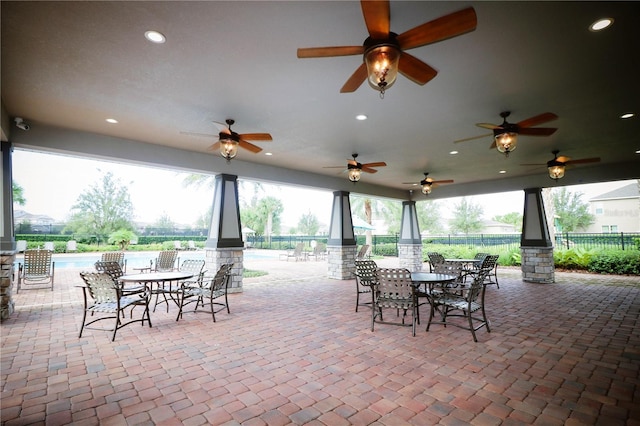 view of patio / terrace with fence, ceiling fan, and outdoor dining space