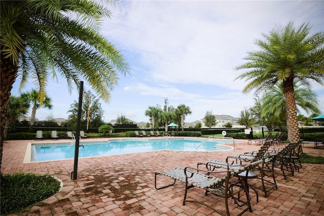 pool with fence and a patio area