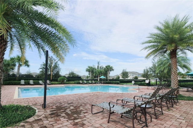 pool with fence and a patio
