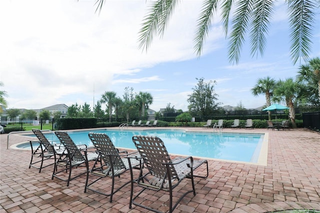 pool featuring fence and a patio area