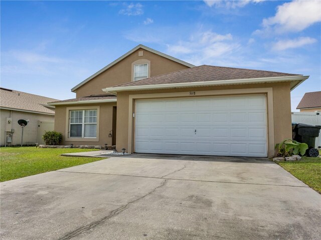 5118 Luna Negra Dr, Orlando, FL 32811 - view of front facade featuring concrete driveway, an attached garage, stucco siding, roof with shingles, and a front yard