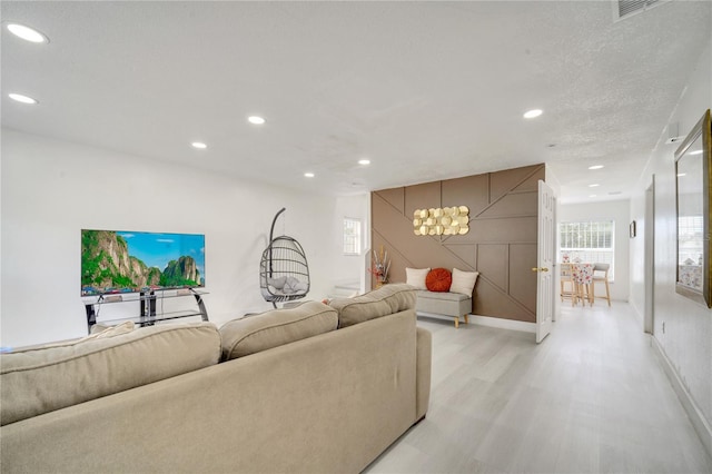 5118 Luna Negra Dr, Orlando, FL 32811 - living area featuring recessed lighting, visible vents, light wood-type flooring, baseboards, and a notable chandelier