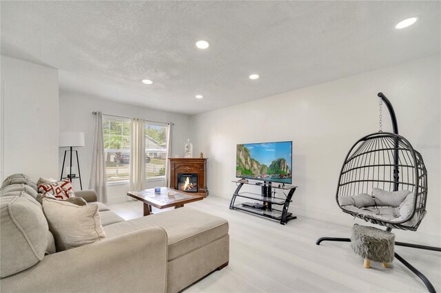 5118 Luna Negra Dr, Orlando, FL 32811 - living room featuring baseboards, a glass covered fireplace, light wood finished floors, and recessed lighting