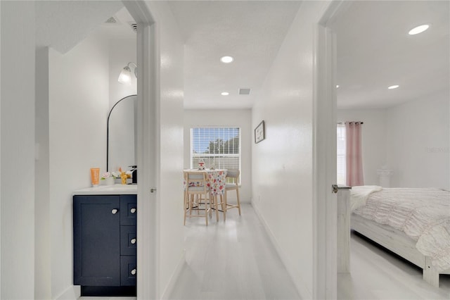5118 Luna Negra Dr, Orlando, FL 32811 - corridor featuring recessed lighting, baseboards, visible vents, and a wealth of natural light