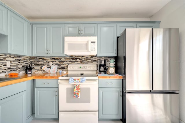 5118 Luna Negra Dr, Orlando, FL 32811 - kitchen with gray cabinets, wooden counters, decorative backsplash, and white appliances