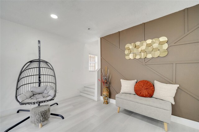 5118 Luna Negra Dr, Orlando, FL 32811 - living area with a decorative wall, wood finished floors, stairs, and recessed lighting