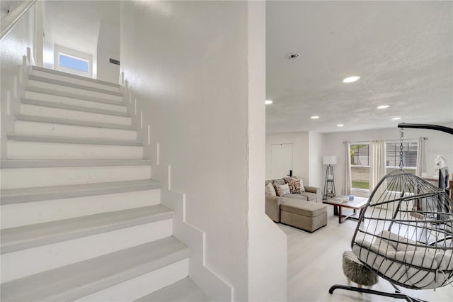 5118 Luna Negra Dr, Orlando, FL 32811 - stairs with wood finished floors and recessed lighting