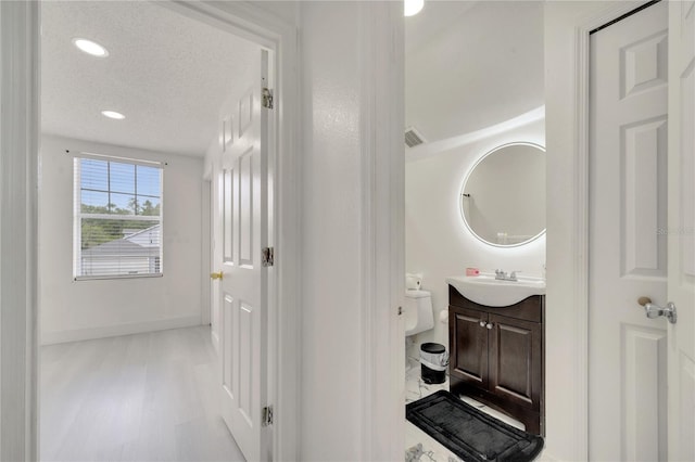 5118 Luna Negra Dr, Orlando, FL 32811 - half bathroom featuring toilet, baseboards, visible vents, recessed lighting, and vanity