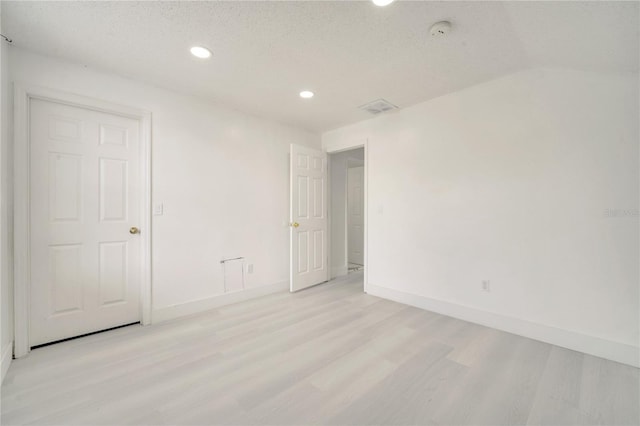 5118 Luna Negra Dr, Orlando, FL 32811 - unfurnished bedroom with light wood-type flooring, baseboards, visible vents, and recessed lighting