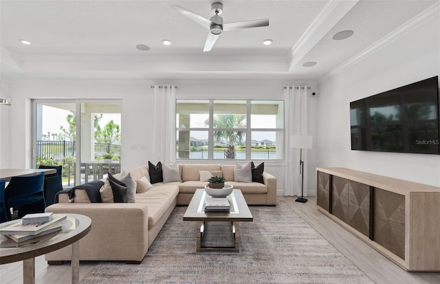 2725 Serenity Meadow Dr, Kissimmee, FL 34744 - living area featuring a raised ceiling, light wood-type flooring, crown molding, and ceiling fan