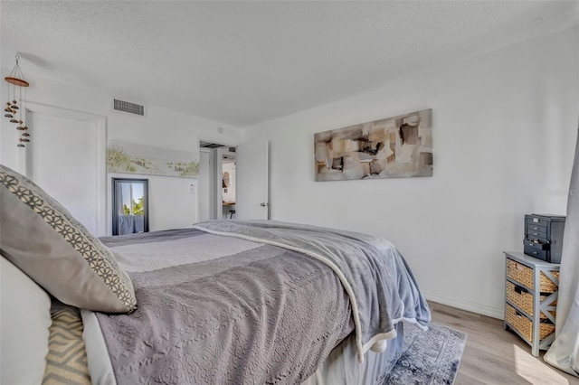 574 Orange Dr Unit 78, Altamonte Springs, FL 32701 - bedroom featuring baseboards, wood finished floors, and visible vents