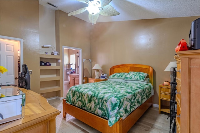 bedroom with light wood finished floors, baseboards, visible vents, ceiling fan, and ensuite bath