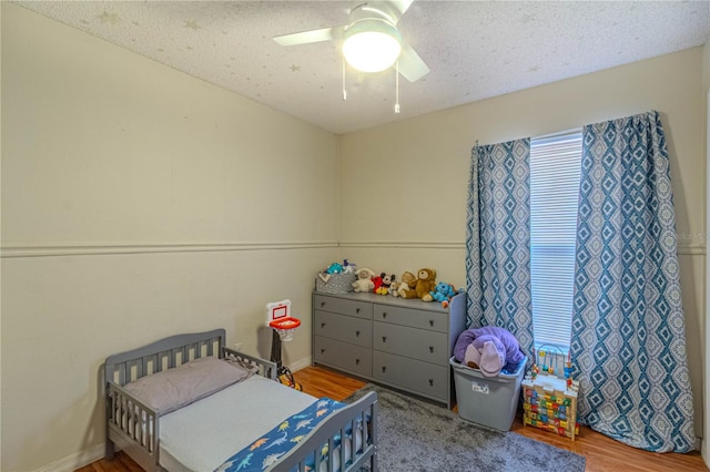 bedroom featuring a ceiling fan and wood finished floors