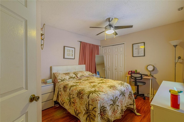 bedroom with a textured ceiling, a closet, and dark wood finished floors