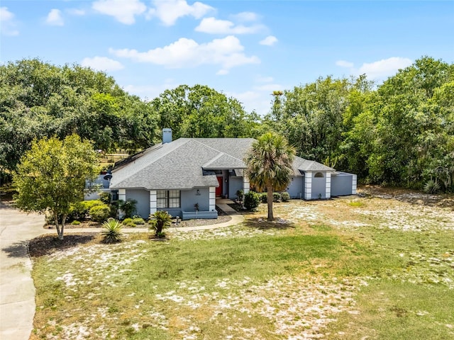 1689 Saboff Way, Chuluota, FL 32766 - view of front facade featuring a shingled roof, a front yard, covered porch, and a garage