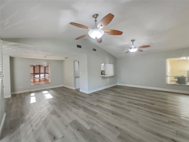 5037 Bermuda Cir Unit 10, Orlando, FL 32808 - unfurnished living room featuring lofted ceiling, visible vents, a ceiling fan, and baseboards
