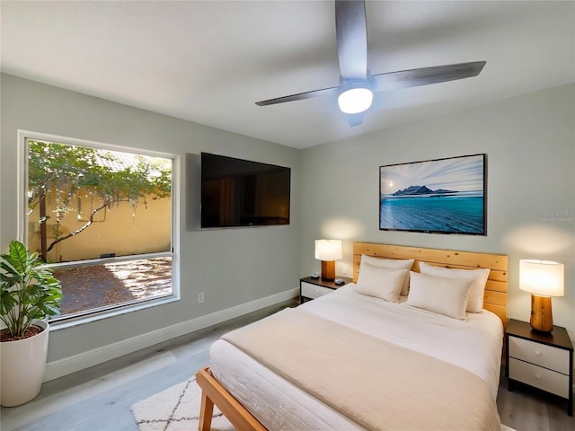 5037 Bermuda Cir Unit 10, Orlando, FL 32808 - bedroom featuring baseboards, a ceiling fan, and wood finished floors