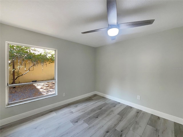 5037 Bermuda Cir Unit 10, Orlando, FL 32808 - unfurnished room featuring baseboards, a ceiling fan, and wood finished floors