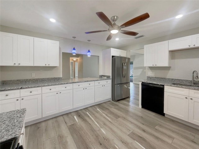 5037 Bermuda Cir Unit 10, Orlando, FL 32808 - kitchen with a sink, visible vents, freestanding refrigerator, black dishwasher, and a ceiling fan