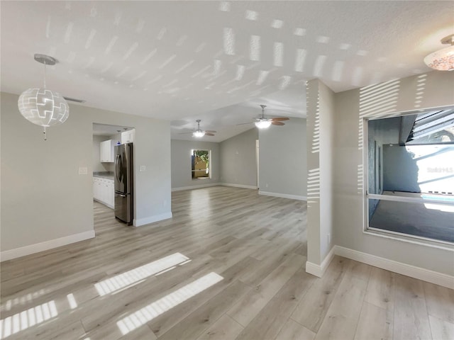 5037 Bermuda Cir Unit 10, Orlando, FL 32808 - unfurnished living room with ceiling fan, baseboards, lofted ceiling, and light wood finished floors