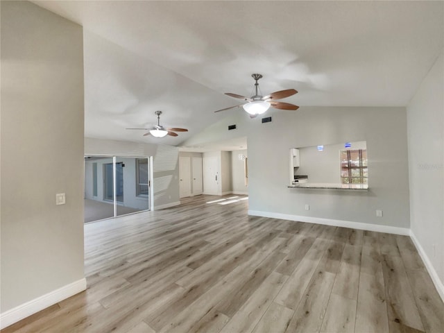 5037 Bermuda Cir Unit 10, Orlando, FL 32808 - unfurnished living room featuring a ceiling fan, wood finished floors, baseboards, lofted ceiling, and visible vents