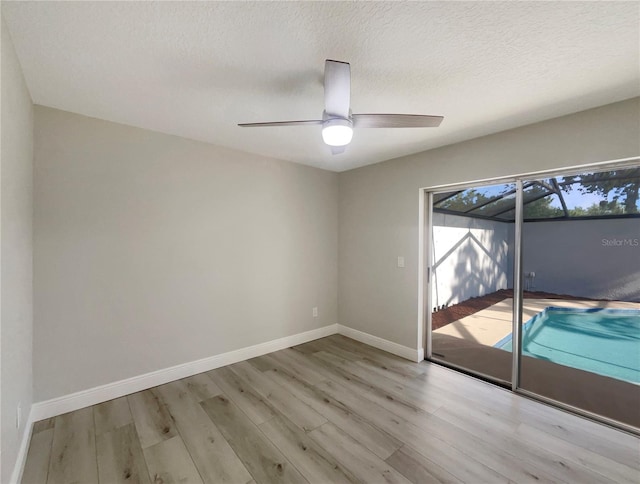 5037 Bermuda Cir Unit 10, Orlando, FL 32808 - unfurnished room with baseboards, wood finished floors, a textured ceiling, and ceiling fan