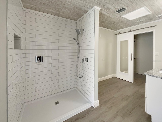 5037 Bermuda Cir Unit 10, Orlando, FL 32808 - bathroom featuring a shower stall, wood finished floors, vanity, baseboards, and visible vents