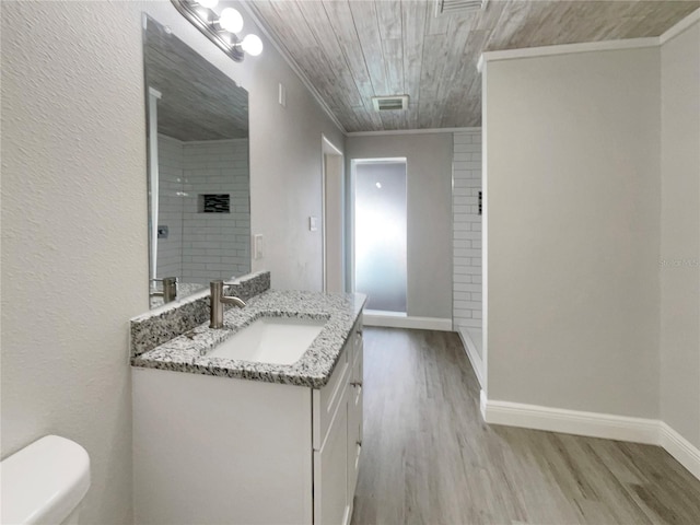 5037 Bermuda Cir Unit 10, Orlando, FL 32808 - bathroom featuring toilet, visible vents, wood finished floors, crown molding, and vanity