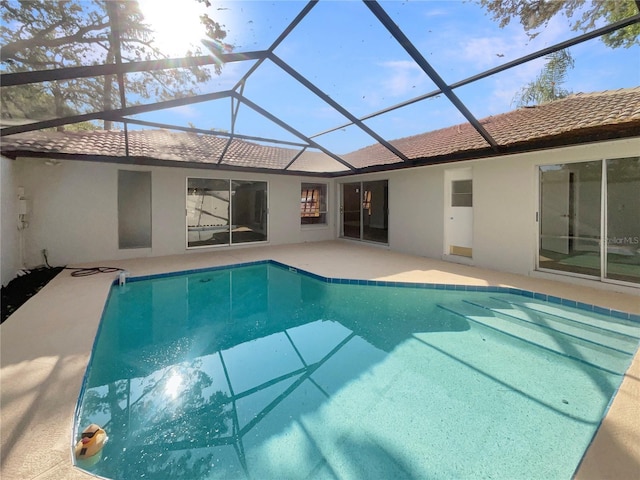 5037 Bermuda Cir Unit 10, Orlando, FL 32808 - back of property with an outdoor pool, glass enclosure, a patio area, and stucco siding