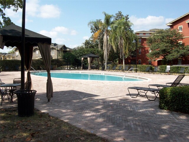 community pool featuring a gazebo and a patio