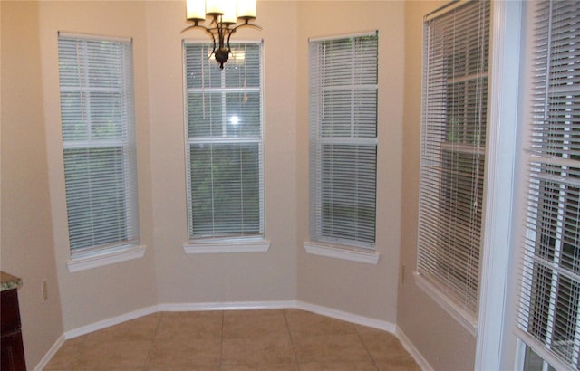 unfurnished dining area featuring tile patterned flooring and baseboards