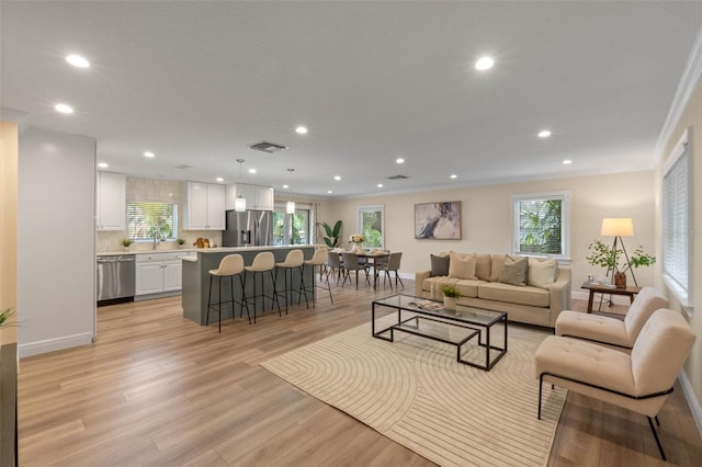1105 Lake Nettie Dr, Eustis, FL 32726 - living area featuring recessed lighting, light wood finished floors, ornamental molding, and baseboards